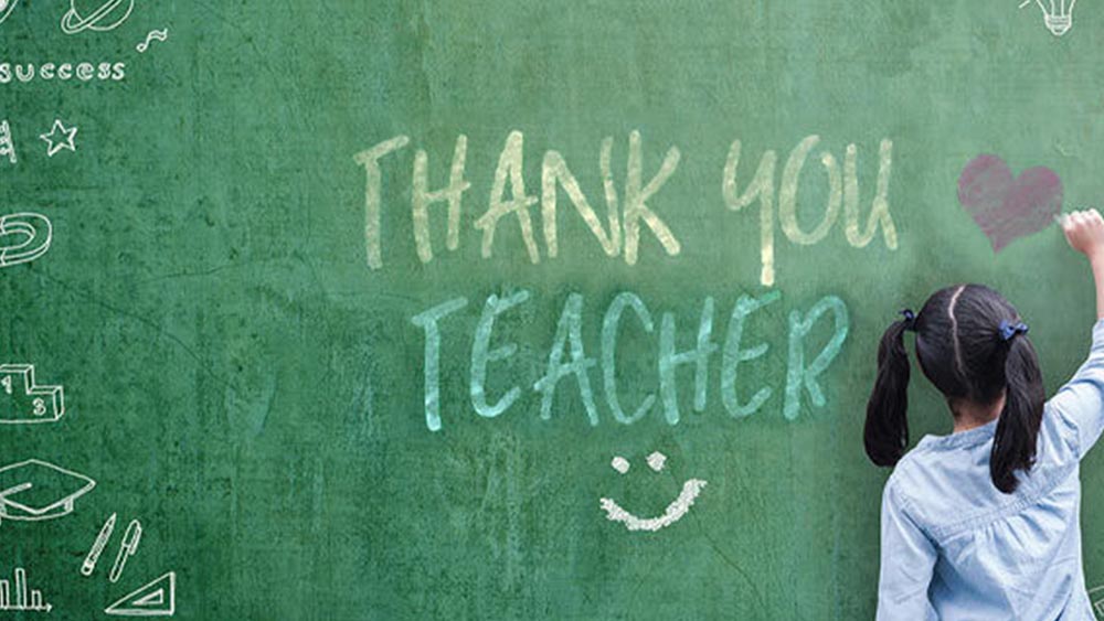 You student writing on a chalkboard